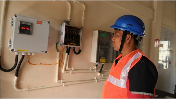  An electrician at St. Joseph Hospital, Karimganj, Assam seen reviewing data on energy generation and consumption from digital energy meters.